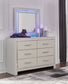 Zyniden King Upholstered Panel Bed with Mirrored Dresser, Chest and Nightstand