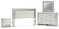 Zyniden King Upholstered Panel Headboard with Mirrored Dresser and Nightstand
